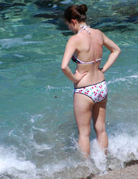 A busty bikini slut undressing on the Bellevue Image 2