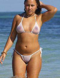 A girl stripping out of her bikini on the Rarawa Nudist Image 1
