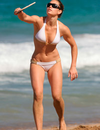 A girl stripping out of her bikini on the Rarawa Nudist Image 5