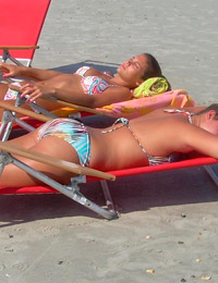 A busty bikini babe undressing on the Peka Peka Image 1