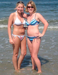 A busty bikini lady undressing on the Natadola Image 9