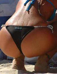 A busty bikini girl undressing on the Coralita Image 7