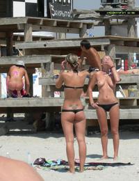 A busty bikini girl undressing on the Coralita Image 8
