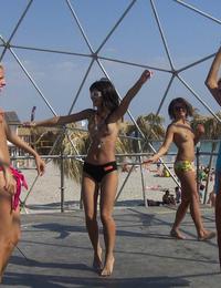 A busty bikini lady undressing on the Cap d'Agde Image 11