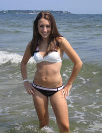 A busty bikini girl undressing on the Rarawa Nudist Image 5