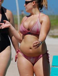 A busty bikini girl undressing on the Rarawa Nudist Image 6